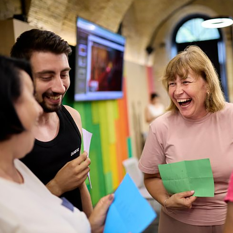 Happy, laughing teachers engaged in a training workshop