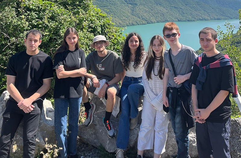 young people outside in nature smiling at the camera