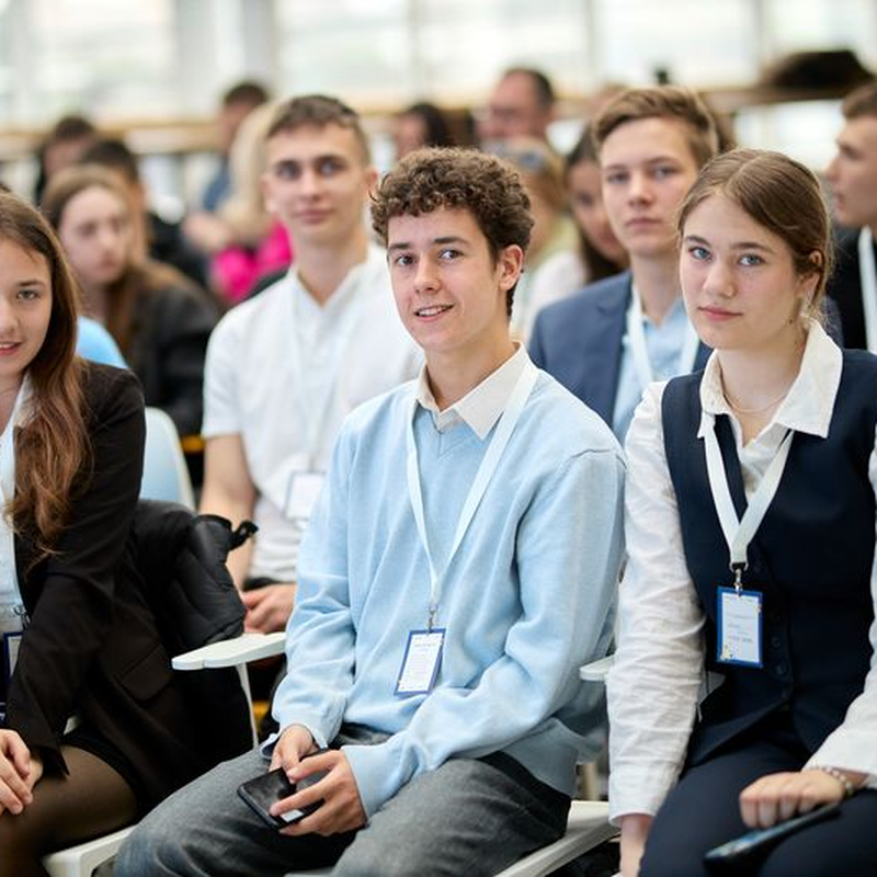 Close up view of students in a lecture, looking at the camera