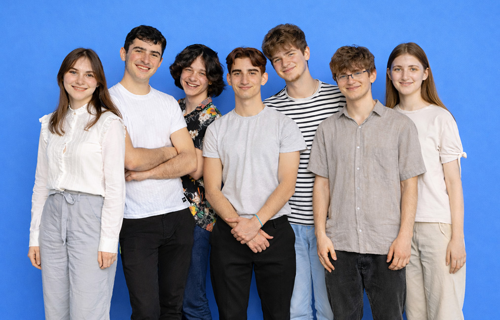 Seven young students looking at the camera with smiling faces