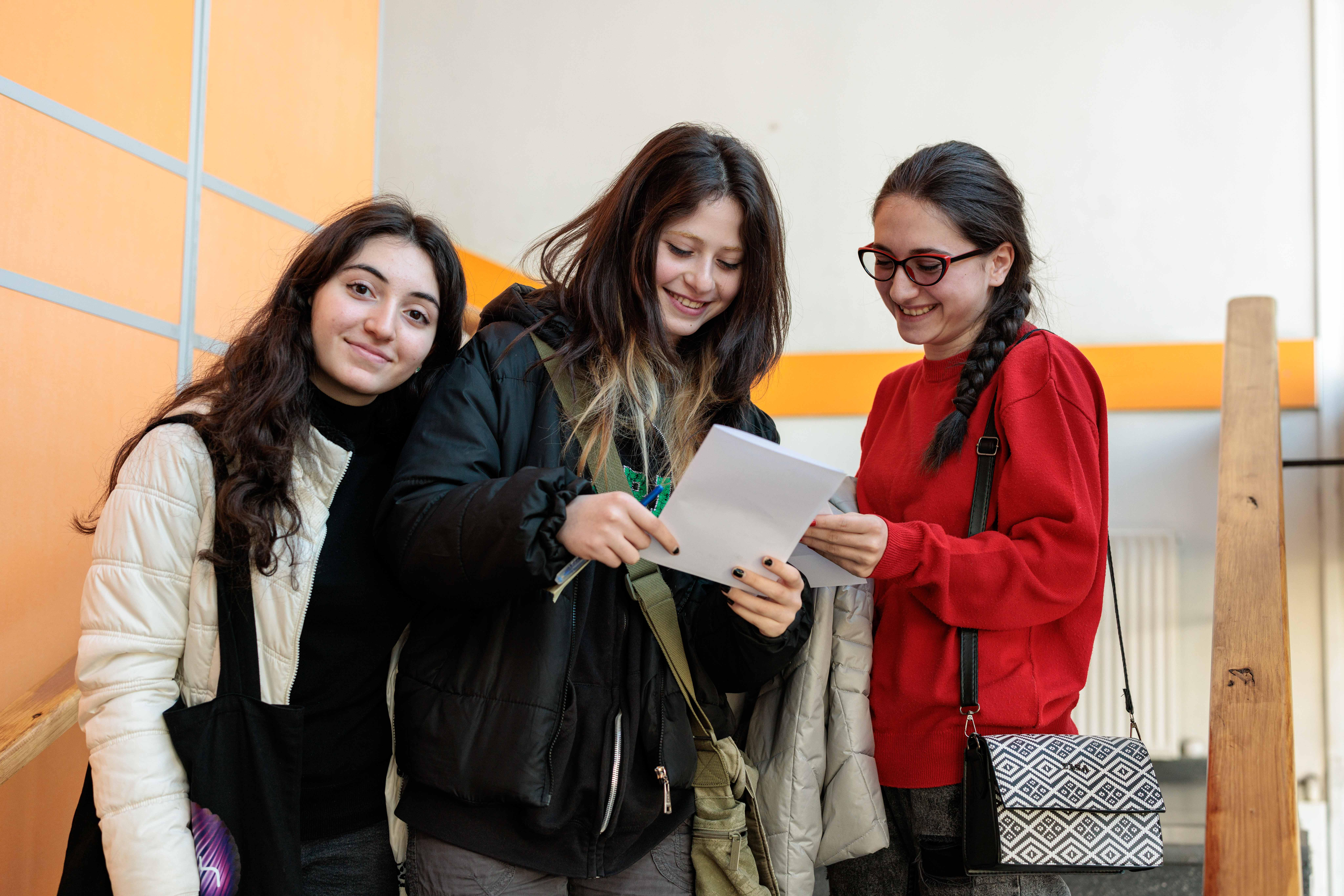 Female students smiling into camera